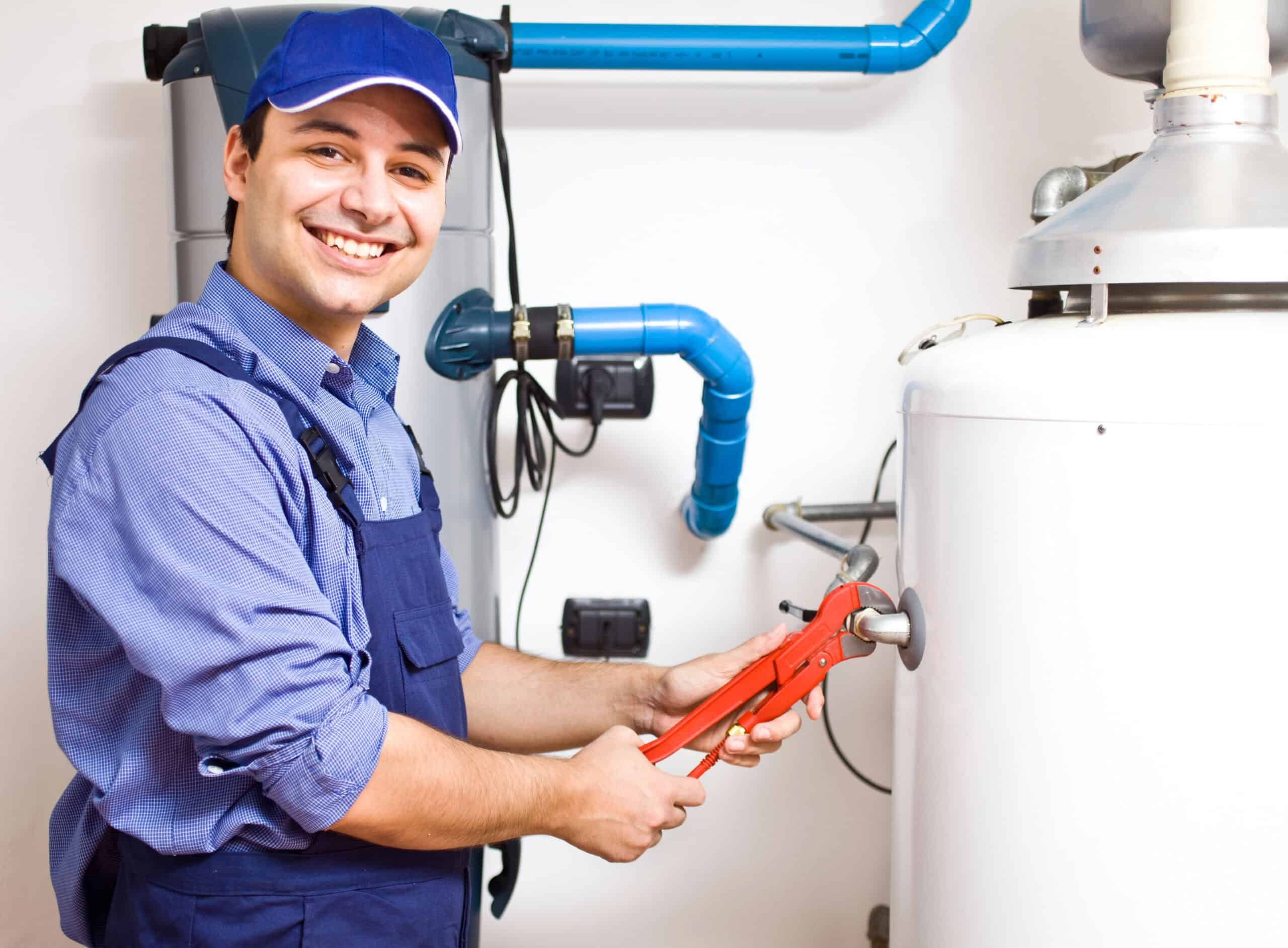 Plumber smiling while performing water heater installation as part of HD Drain Cleaning’s services in Ormond Beach, FL