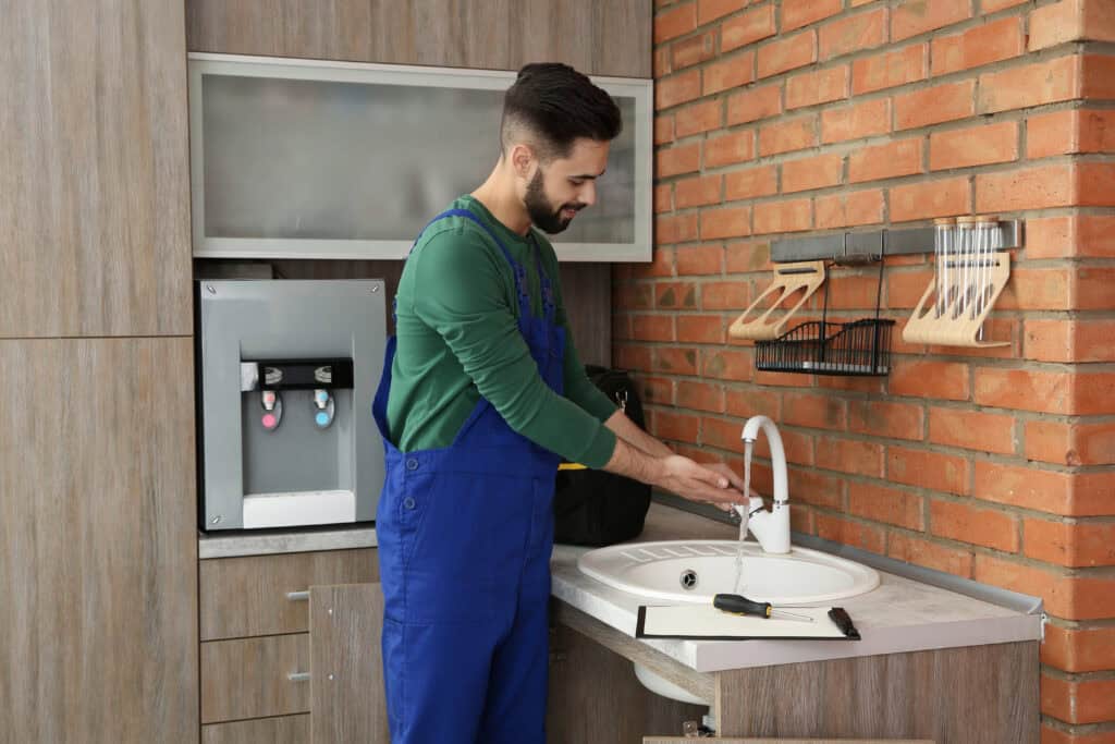 Plumber performing faucet repair at a kitchen sink as part of HD Drain Cleaning’s faucet repair services in Ormond Beach, FL